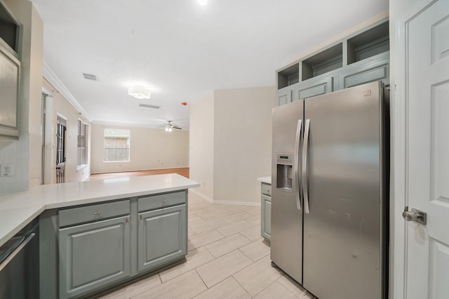 718 Presley Way, Sugar Land, TX 77479 - kitchen with stainless steel fridge with ice dispenser, a peninsula, gray cabinetry, light countertops, and open shelves