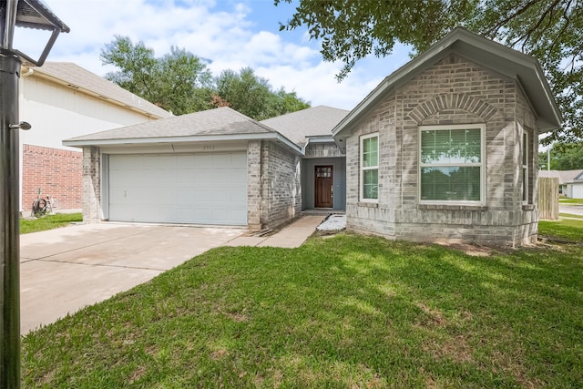 2902 Secluded Dr, Sugar Land, TX 77498 - view of front of home featuring an attached garage, concrete driveway, a front yard, and brick siding