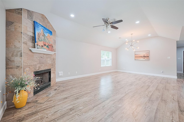 2902 Secluded Dr, Sugar Land, TX 77498 - unfurnished living room with vaulted ceiling, wood finished floors, a ceiling fan, a fireplace, and a chandelier