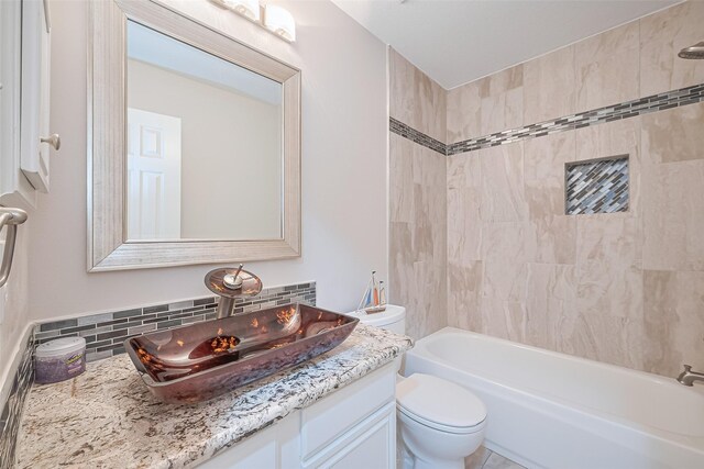 2902 Secluded Dr, Sugar Land, TX 77498 - bathroom with vanity, toilet, decorative backsplash, and shower / washtub combination