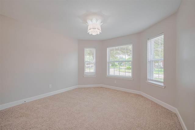 2902 Secluded Dr, Sugar Land, TX 77498 - empty room with plenty of natural light, light colored carpet, and baseboards