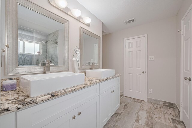 2902 Secluded Dr, Sugar Land, TX 77498 - bathroom with vanity, tiled shower, and baseboards