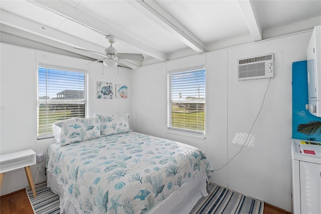 512 Surf Dr, Freeport, TX 77541 - bedroom featuring multiple windows, beam ceiling, wood finished floors, a wall mounted AC, and a ceiling fan