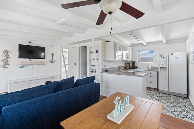 512 Surf Dr, Freeport, TX 77541 - dining area with beamed ceiling, light wood-style flooring, and ceiling fan