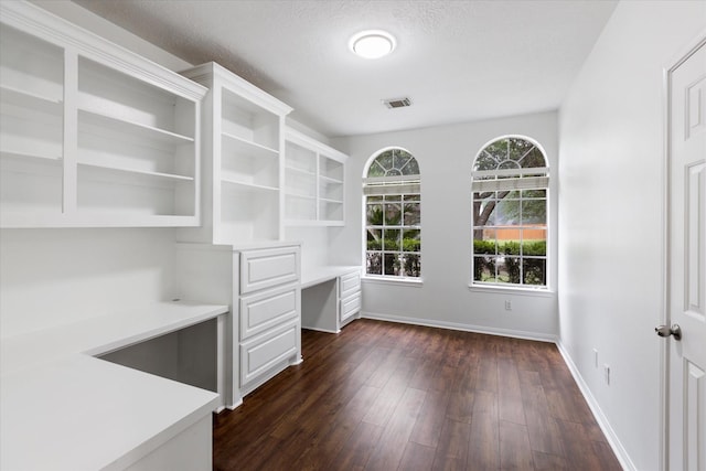 1919 W Welsford Dr, Spring, TX 77386 - unfurnished office featuring built in study area, baseboards, dark wood-type flooring, and a textured ceiling