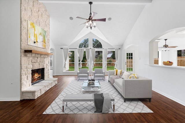 1919 W Welsford Dr, Spring, TX 77386 - living room featuring a ceiling fan, wood finished floors, a stone fireplace, baseboards, and arched walkways