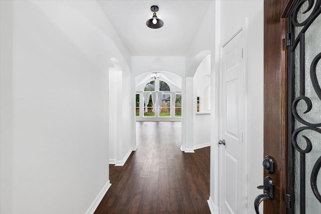 1919 W Welsford Dr, Spring, TX 77386 - foyer entrance featuring baseboards, dark wood-style floors, arched walkways, and a ceiling fan
