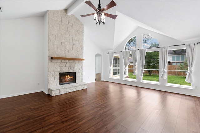 1919 W Welsford Dr, Spring, TX 77386 - unfurnished living room featuring a ceiling fan, wood finished floors, a fireplace, beam ceiling, and high vaulted ceiling