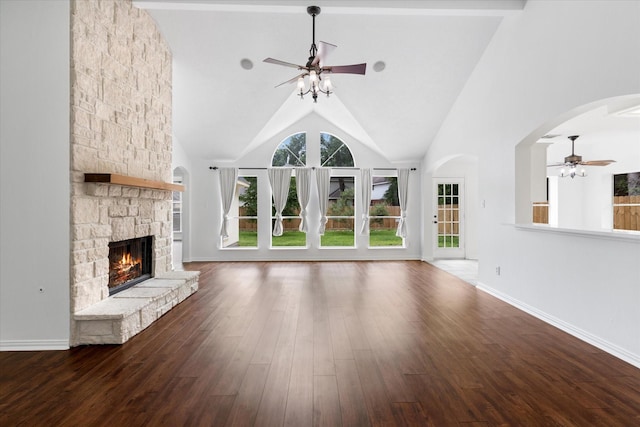 1919 W Welsford Dr, Spring, TX 77386 - unfurnished living room featuring ceiling fan, a stone fireplace, wood finished floors, high vaulted ceiling, and baseboards
