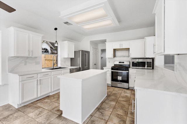 1919 W Welsford Dr, Spring, TX 77386 - kitchen featuring stainless steel appliances, a sink, white cabinetry, and a kitchen island