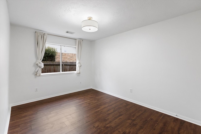 1919 W Welsford Dr, Spring, TX 77386 - empty room with wood finished floors, baseboards, and a textured ceiling