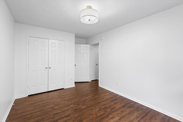1919 W Welsford Dr, Spring, TX 77386 - unfurnished bedroom featuring baseboards, dark wood finished floors, and a closet