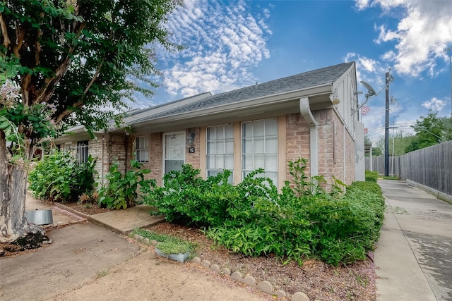 1016 Tri Oaks Ln Unit 92, Houston, TX 77043 - view of side of property with brick siding and roof with shingles