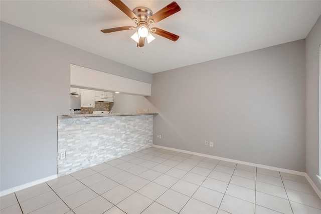 1016 Tri Oaks Ln Unit 92, Houston, TX 77043 - unfurnished room with a ceiling fan, baseboards, and light tile patterned floors