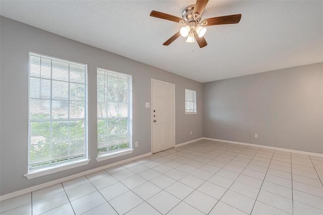 1016 Tri Oaks Ln Unit 92, Houston, TX 77043 - foyer featuring a ceiling fan, baseboards, and light tile patterned floors