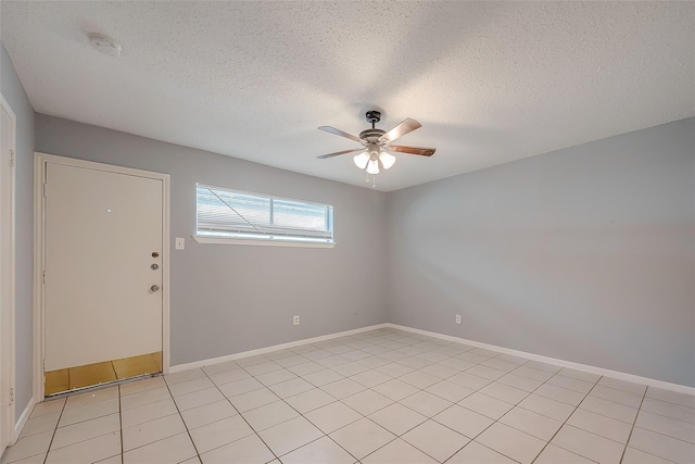 1016 Tri Oaks Ln Unit 92, Houston, TX 77043 - spare room featuring ceiling fan, a smoke detector, a textured ceiling, baseboards, and light tile patterned flooring
