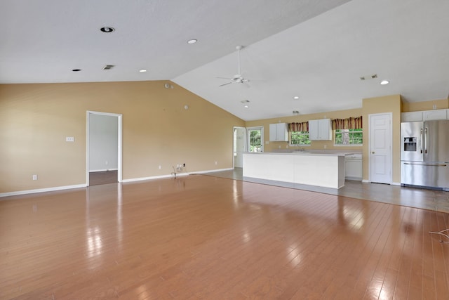 360 Holiday Ln, Coldspring, TX 77331 - unfurnished living room with vaulted ceiling, a ceiling fan, baseboards, and light wood-style flooring