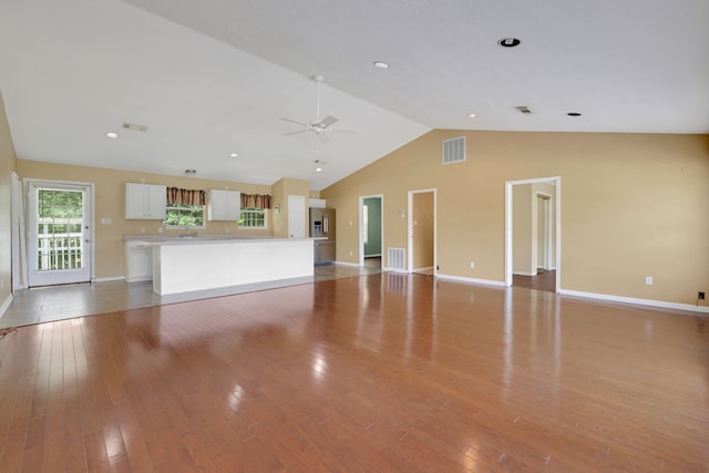 360 Holiday Ln, Coldspring, TX 77331 - unfurnished living room with a ceiling fan, baseboards, light wood-style floors, and high vaulted ceiling
