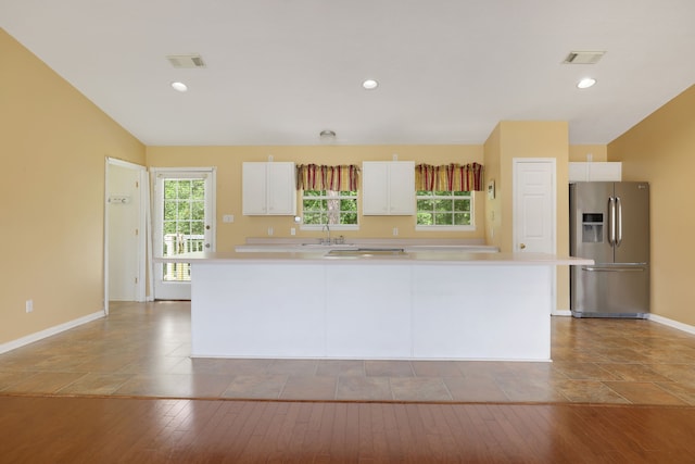 360 Holiday Ln, Coldspring, TX 77331 - kitchen featuring stainless steel fridge, white cabinetry, light countertops, baseboards, and recessed lighting