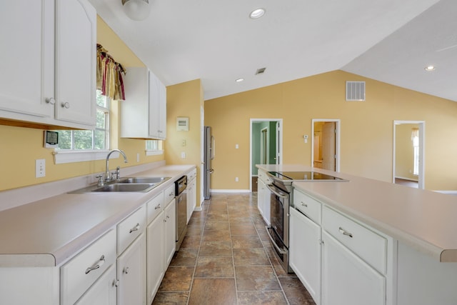 360 Holiday Ln, Coldspring, TX 77331 - kitchen featuring stainless steel appliances, a sink, white cabinets, lofted ceiling, and light countertops