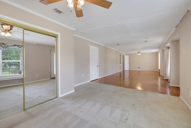 360 Holiday Ln, Coldspring, TX 77331 - carpeted spare room with ceiling fan, baseboards, crown molding, and wood finished floors