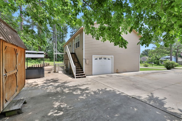 360 Holiday Ln, Coldspring, TX 77331 - view of property exterior featuring a garage, stairway, and concrete driveway