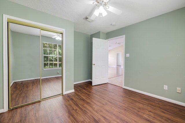 360 Holiday Ln, Coldspring, TX 77331 - unfurnished bedroom with wood finished floors, baseboards, and a closet