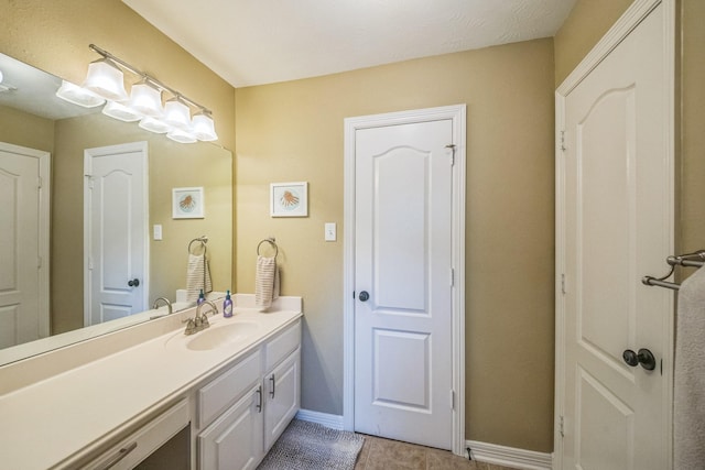 17407 W Blooming Rose Ct, Cypress, TX 77429 - bathroom with vanity, baseboards, and tile patterned floors