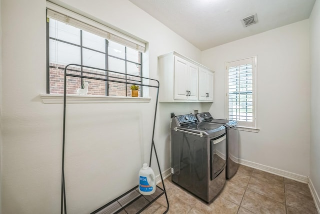 17407 W Blooming Rose Ct, Cypress, TX 77429 - laundry area featuring cabinet space, washer and dryer, baseboards, and light tile patterned floors