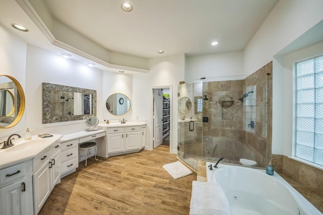 17407 W Blooming Rose Ct, Cypress, TX 77429 - bathroom with a shower stall, vanity, a jetted tub, a walk in closet, and wood finished floors