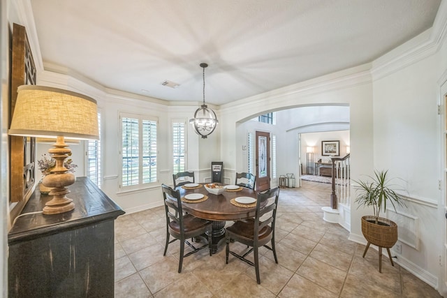 17407 W Blooming Rose Ct, Cypress, TX 77429 - dining space featuring arched walkways, light tile patterned floors, a chandelier, and crown molding