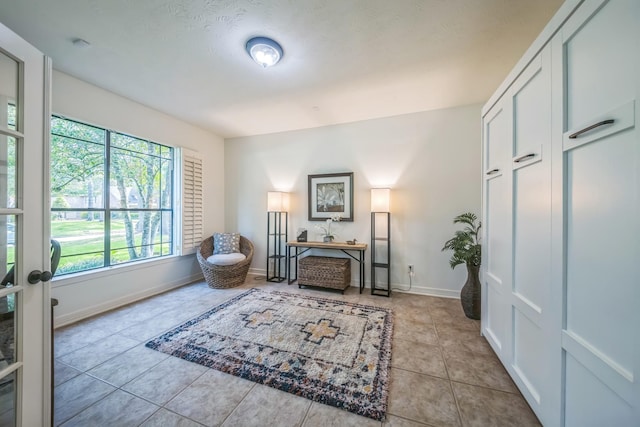 17407 W Blooming Rose Ct, Cypress, TX 77429 - living area featuring healthy amount of natural light, tile patterned flooring, and baseboards