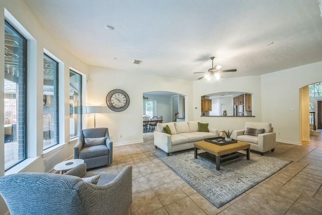 17407 W Blooming Rose Ct, Cypress, TX 77429 - living room featuring arched walkways, ceiling fan, and baseboards