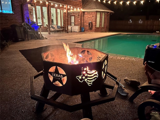 17407 W Blooming Rose Ct, Cypress, TX 77429 - view of swimming pool featuring an outdoor fire pit and a patio