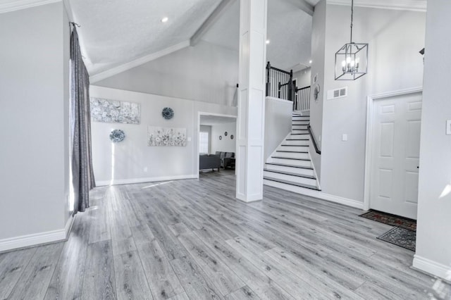 3031 Creek Manor Dr, Houston, TX 77339 - unfurnished living room featuring high vaulted ceiling, stairway, a chandelier, wood finished floors, and baseboards