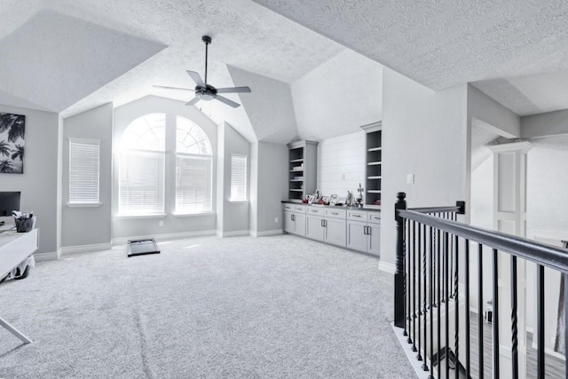3031 Creek Manor Dr, Houston, TX 77339 - living area with ceiling fan, light colored carpet, built in features, a textured ceiling, and baseboards