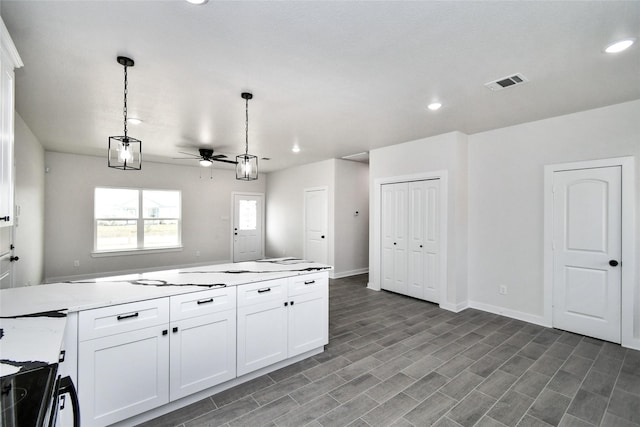 14747 Echo Pines Ct, Conroe, TX 77306 - kitchen featuring ceiling fan, recessed lighting, hanging light fixtures, white cabinetry, and baseboards