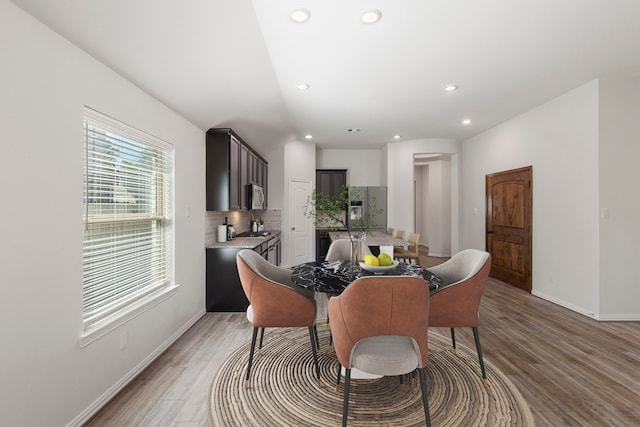 121 N Cadence Hills Loop, Conroe, TX 77318 - dining space with light wood finished floors, recessed lighting, and lofted ceiling