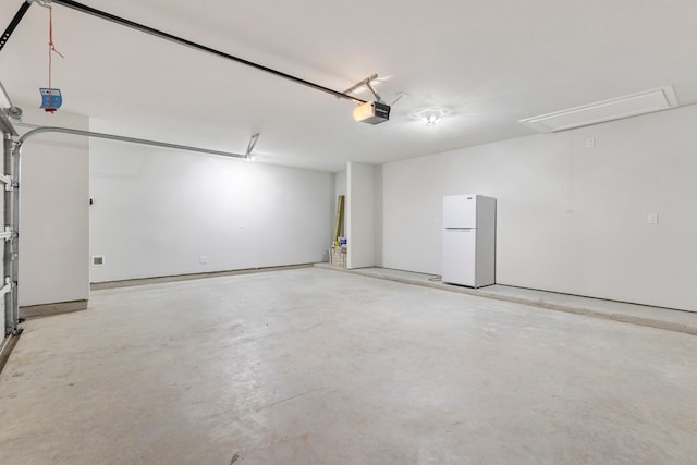 121 N Cadence Hills Loop, Conroe, TX 77318 - garage with freestanding refrigerator and a garage door opener
