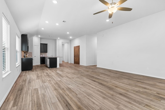 121 N Cadence Hills Loop, Conroe, TX 77318 - unfurnished living room with light wood-style floors, a ceiling fan, and recessed lighting