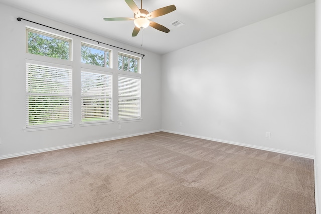 121 N Cadence Hills Loop, Conroe, TX 77318 - spare room with light carpet, ceiling fan, and healthy amount of natural light
