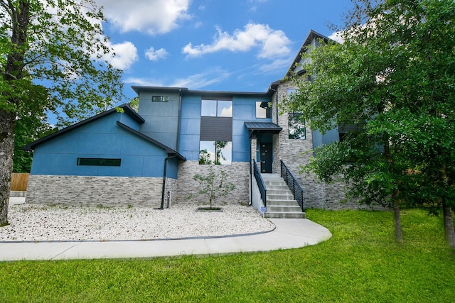 11007 Olde Mint House Ln, Tomball, TX 77375 - modern home featuring stone siding and a front lawn