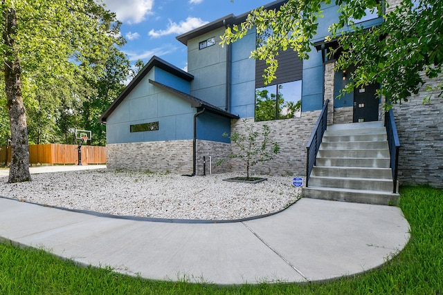 11007 Olde Mint House Ln, Tomball, TX 77375 - view of property exterior with stone siding