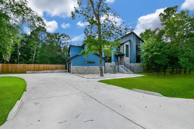 11007 Olde Mint House Ln, Tomball, TX 77375 - view of front of house featuring stone siding, driveway, and a garage