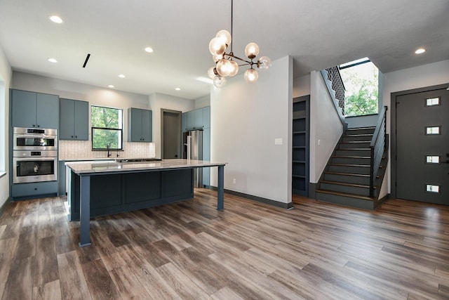 11007 Olde Mint House Ln, Tomball, TX 77375 - kitchen featuring healthy amount of natural light, appliances with stainless steel finishes, a center island, backsplash, and recessed lighting