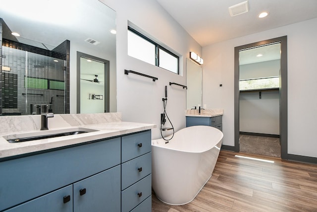 11007 Olde Mint House Ln, Tomball, TX 77375 - full bathroom with a stall shower, vanity, plenty of natural light, wood finished floors, and recessed lighting