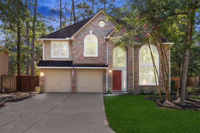 34 Lightwood Trce, The Woodlands, TX 77382 - view of front of home with concrete driveway, brick siding, and a garage