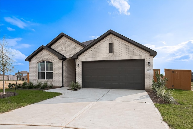 27227 Blue Pool Dr, Katy, TX 77493 - french provincial home featuring driveway, a garage, brick siding, and a front lawn