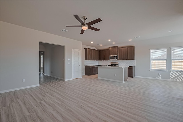 27227 Blue Pool Dr, Katy, TX 77493 - kitchen featuring appliances with stainless steel finishes, open floor plan, ceiling fan, light countertops, and recessed lighting