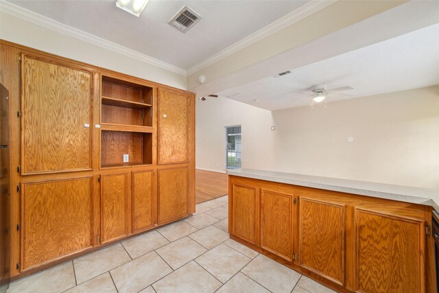 4934 Lamonte Ln, Houston, TX 77092 - kitchen featuring brown cabinetry, a ceiling fan, light tile patterned floors, ornamental molding, and light countertops